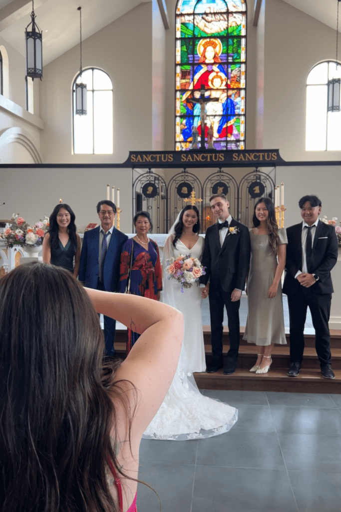 Behind-the-scenes of a photographer directing a couple during their wedding portraits