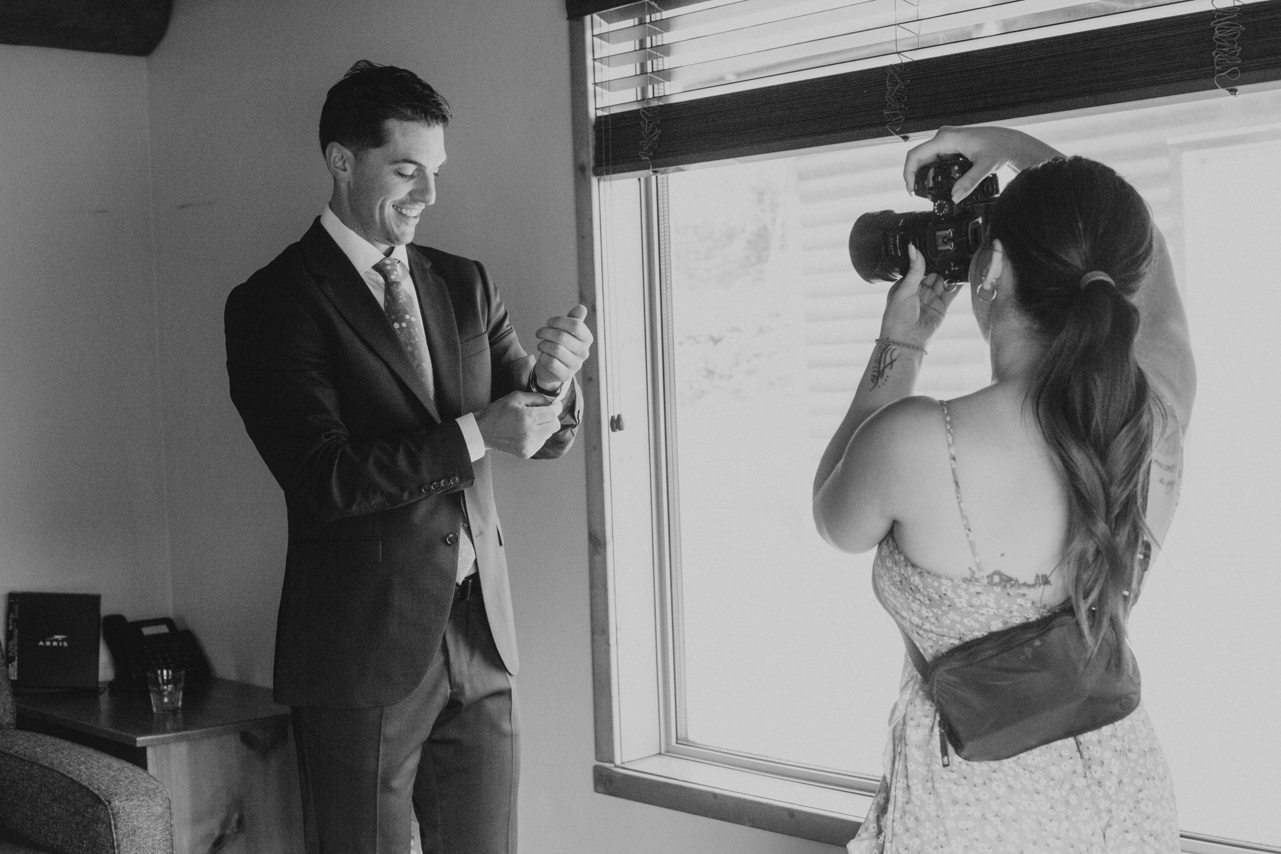 Photographer photographing groom on wedding day.