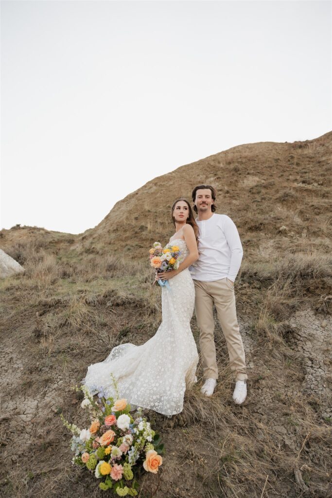 Couple posing for their colorful and fun wedding photos - Saskatchewan wedding 
