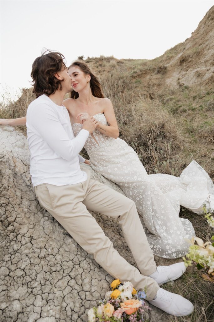 a couple in saskatchewan getting wedding portraits taking with colorful bouquets