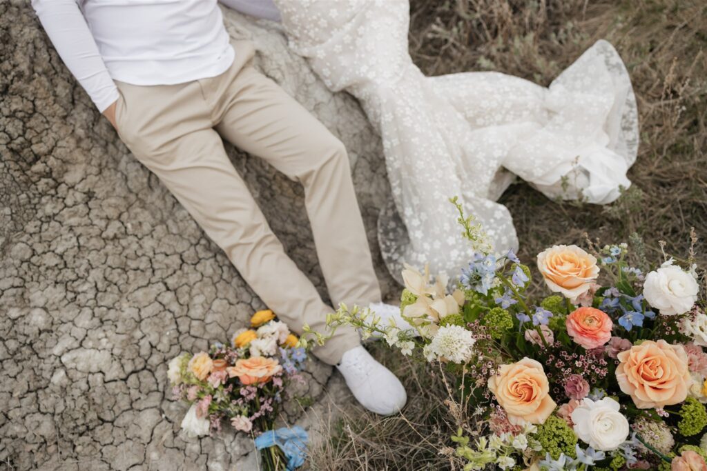 a couple in saskatchewan getting wedding portraits taking with colorful bouquets