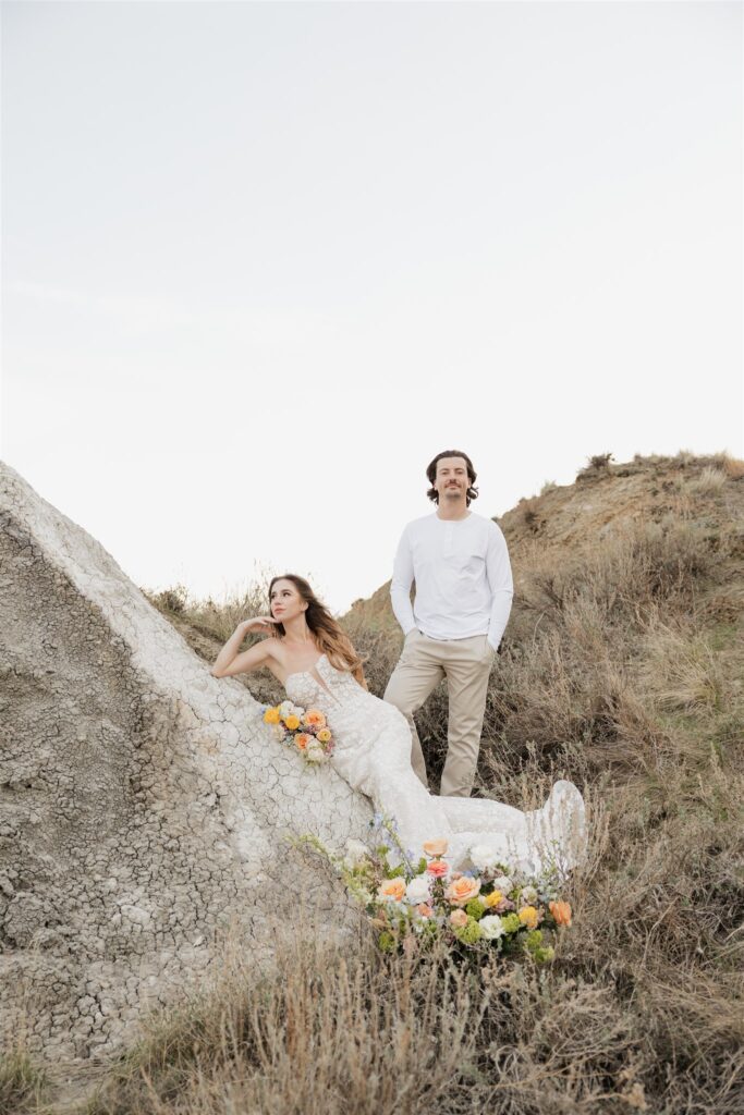 a couple in saskatchewan getting wedding portraits taking with colorful bouquets