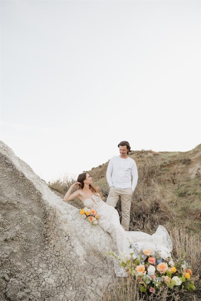 a couple in saskatchewan getting wedding portraits taking with colorful bouquets