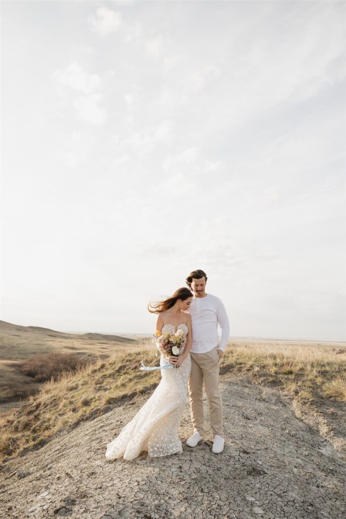 Couple posing for their colorful and fun wedding photos - Saskatchewan wedding