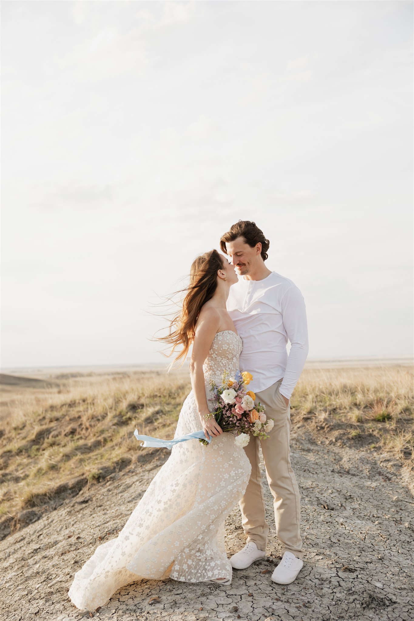 Couple posing for their colorful and fun wedding photos - Saskatchewan wedding