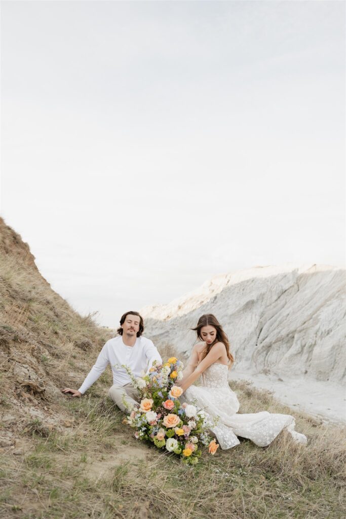 a couple in saskatchewan getting wedding portraits taking with colorful bouquets