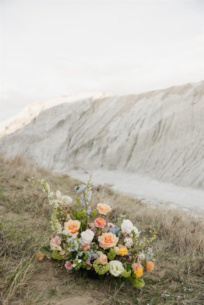 a couple in saskatchewan getting wedding portraits taking with colorful bouquets