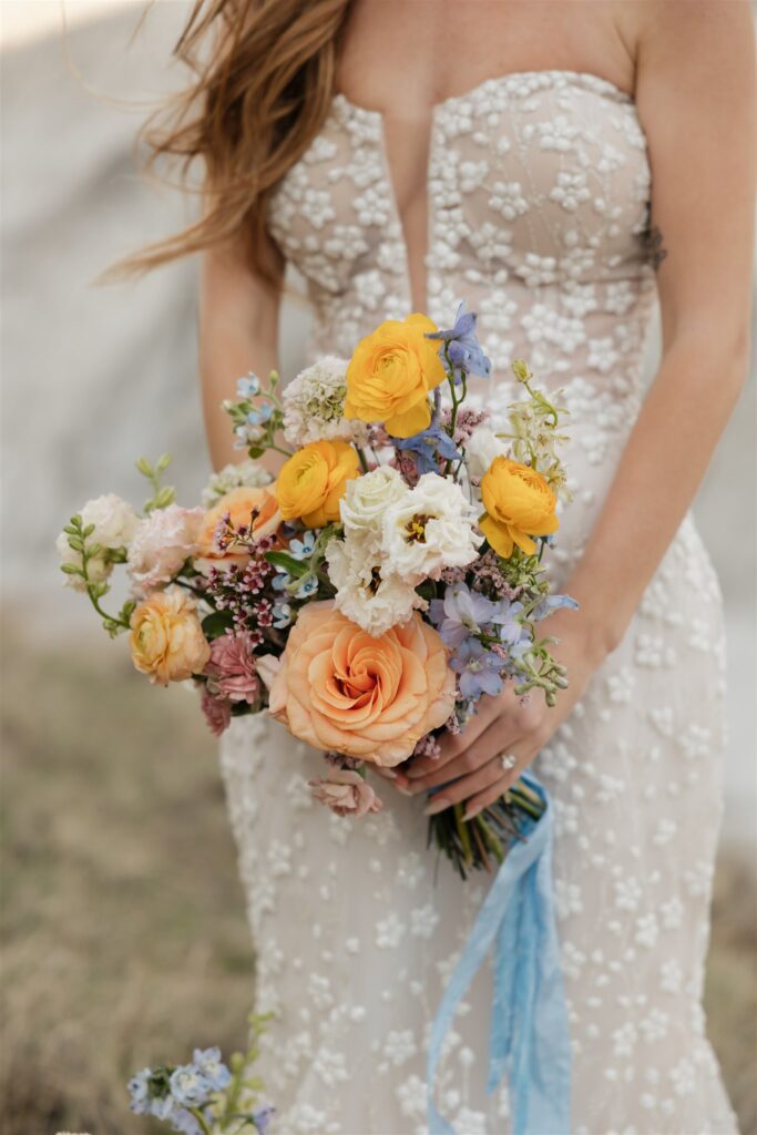 a couple in saskatchewan getting wedding portraits taking with colorful bouquets