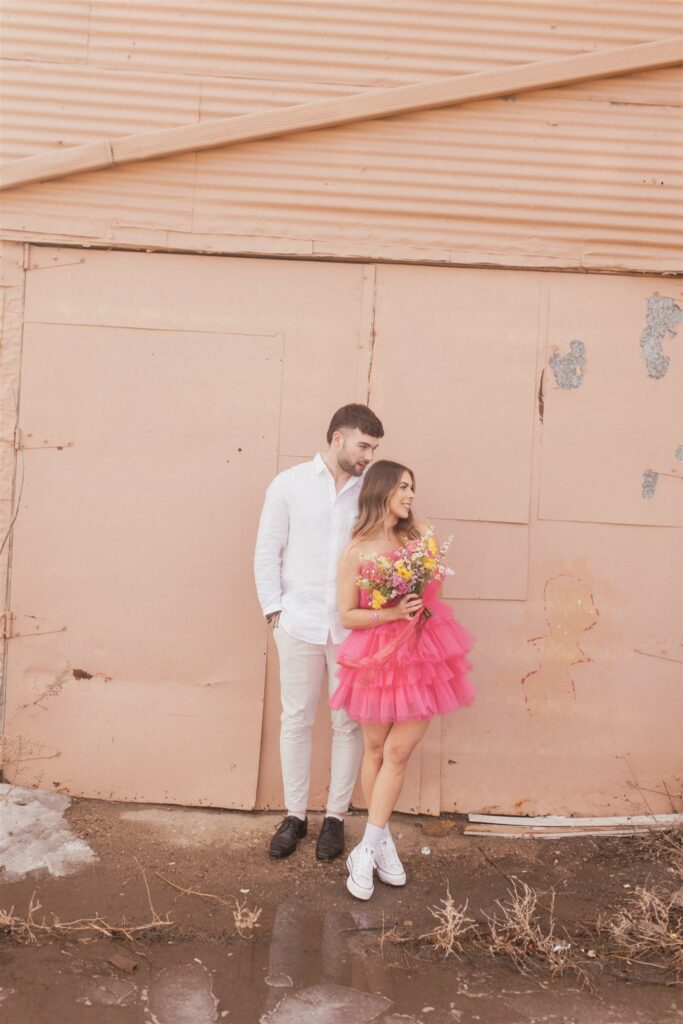 a couple playing and posing for a bright and vibrant photoshoot downtown