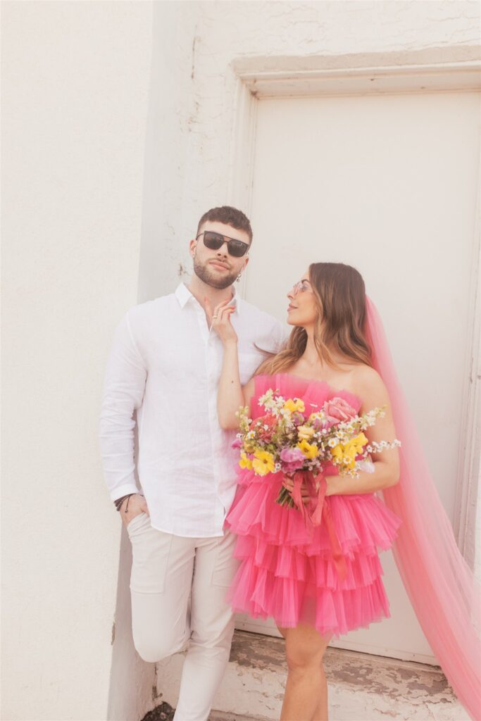 a couple playing and posing for a bright and vibrant photoshoot downtown