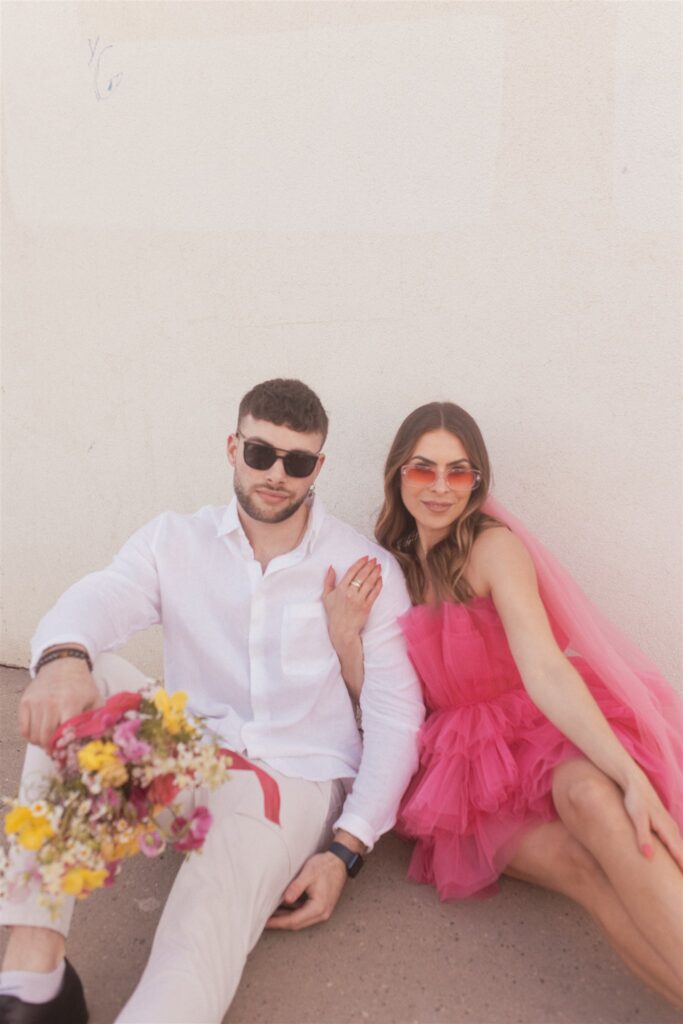 a couple playing and posing for a bright and vibrant photoshoot downtown