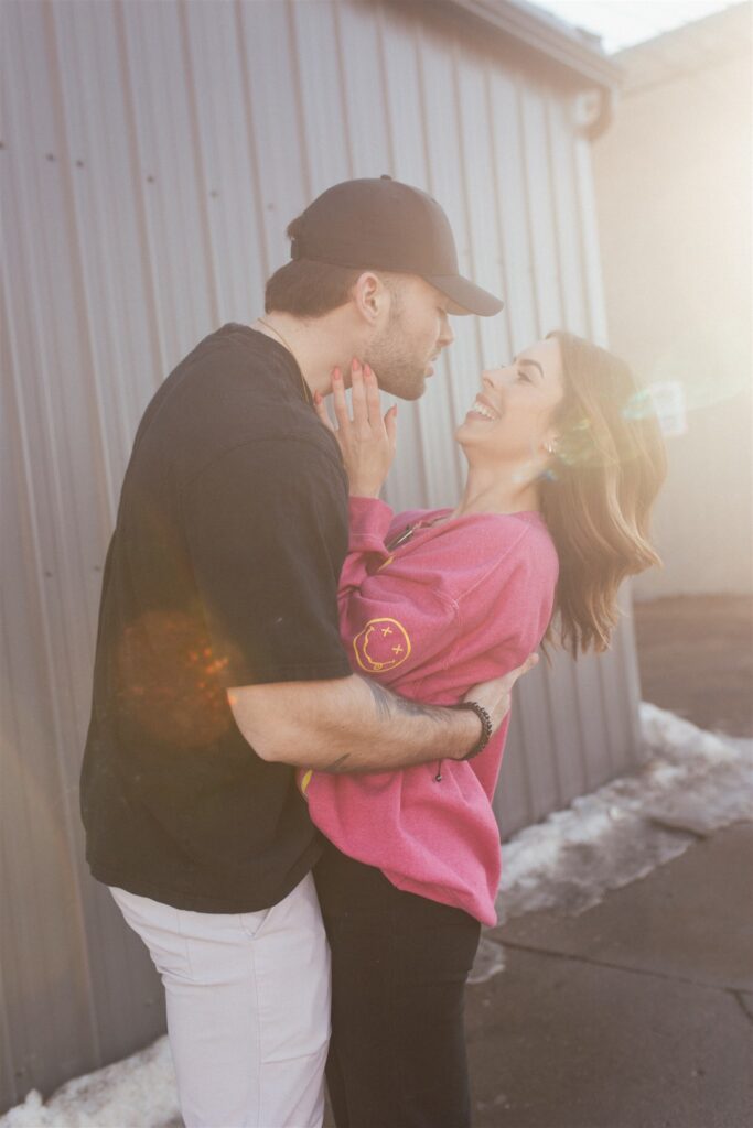 a couple playing and posing for a bright and vibrant photoshoot downtown