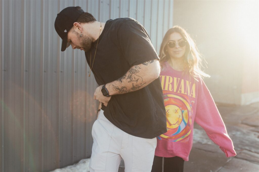 a couple playing and posing for a bright and vibrant photoshoot downtown