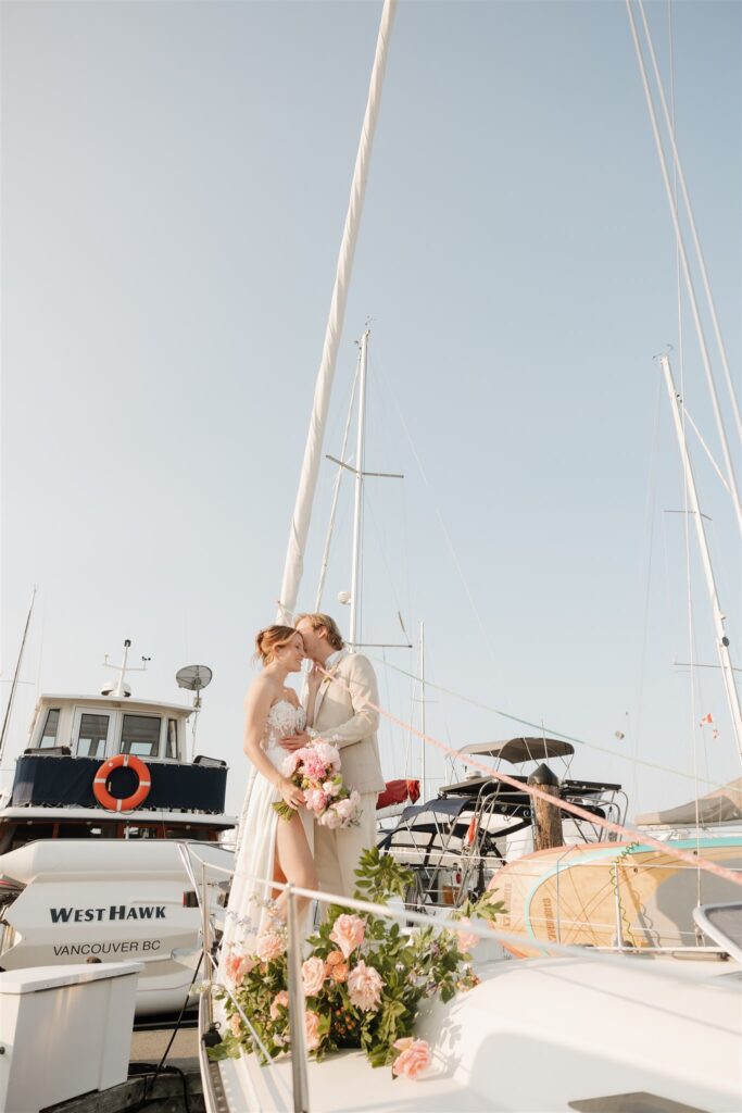 a couple posing with colorful flower on a boat for elopement pictures