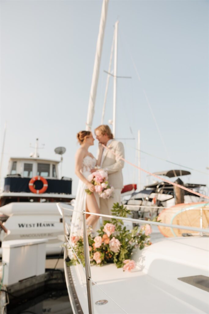 a couple posing with colorful flower on a boat for elopement pictures
