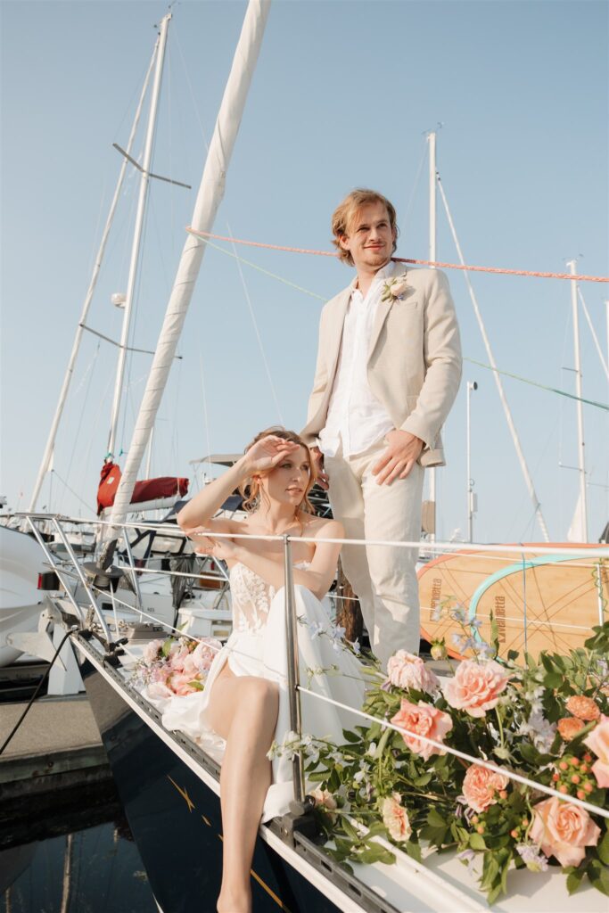 a couple posing with colorful flower on a boat for elopement pictures
