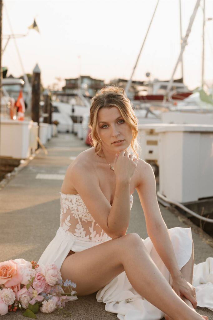 Couple posing on a boat for their colorful elopement in british columbia - sailboat elopement
