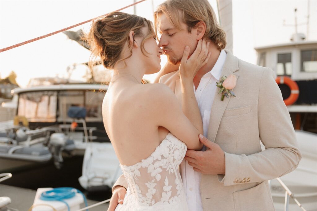 Couple posing on a boat for their colorful elopement in british columbia - sailboat elopement
