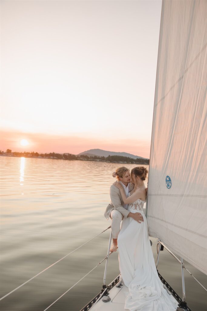 a couple posing with colorful flower on a boat for elopement pictures
