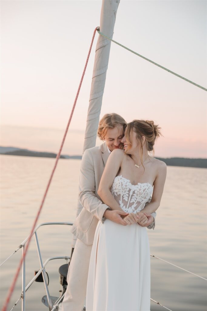 a couple posing with colorful flower on a boat for elopement pictures
