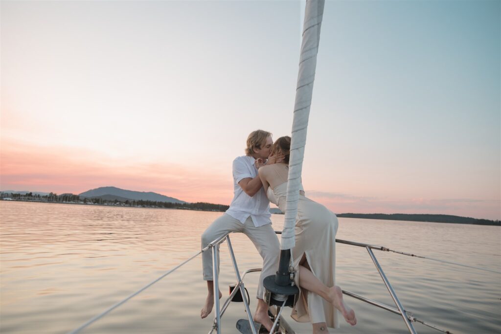 Couple posing on a boat for their colorful elopement in british columbia - sailboat elopement
