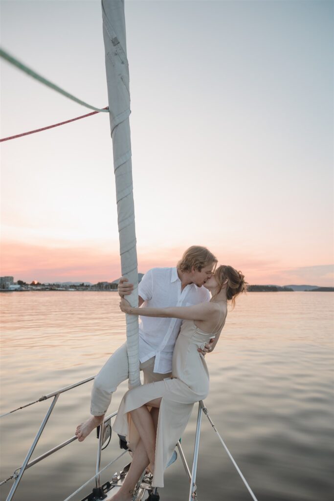 Couple posing on a boat for their colorful elopement in british columbia - sailboat elopement
