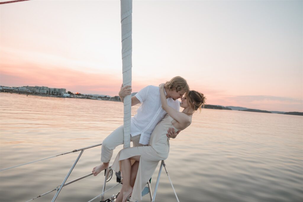 Couple posing on a boat for their colorful elopement in british columbia - sailboat elopement
