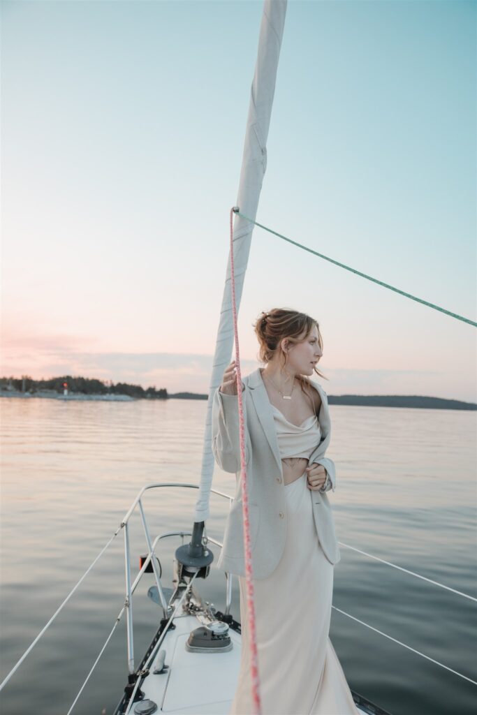 Couple posing on a boat for their colorful elopement in british columbia - sailboat elopement
