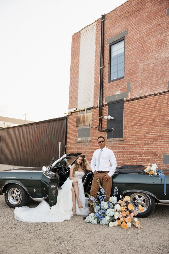 bride and groom posing in an urban setting for their downtown wedding portraits - editorial wedding photos
