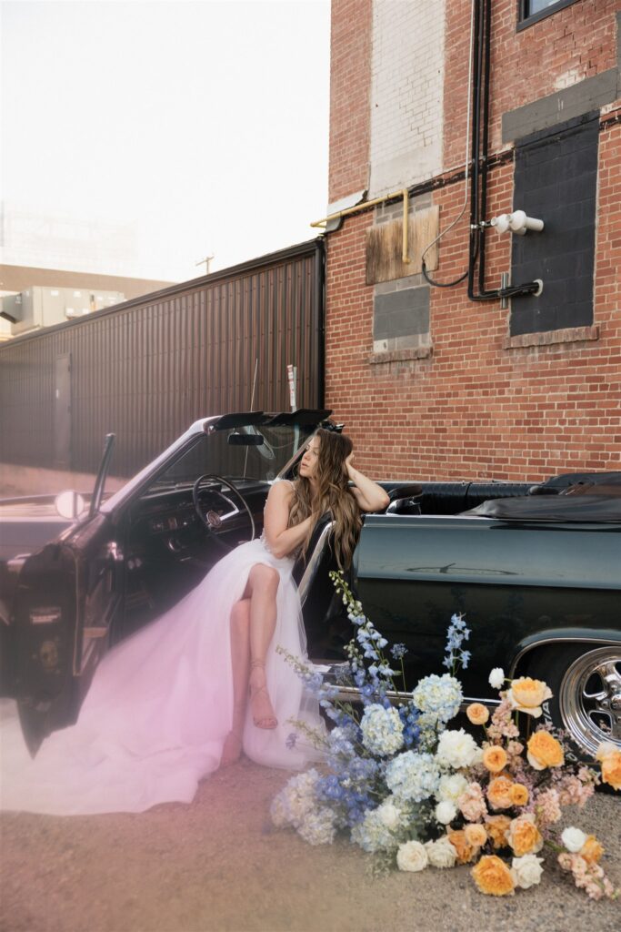 bride and groom posing in an urban setting for their downtown wedding portraits - editorial wedding photos
