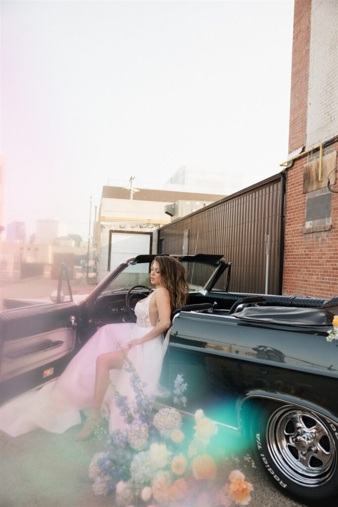 bride and groom posing in an urban setting for their downtown wedding portraits - editorial wedding photos
