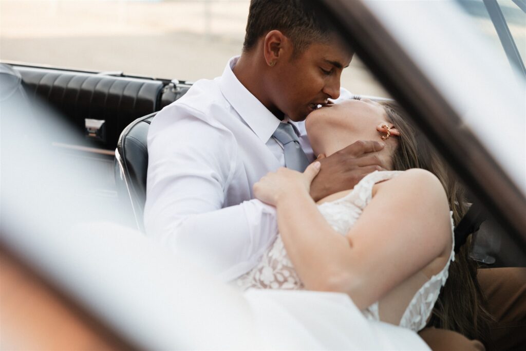 bride and groom posing in an urban setting for their downtown wedding portraits - editorial wedding photos
