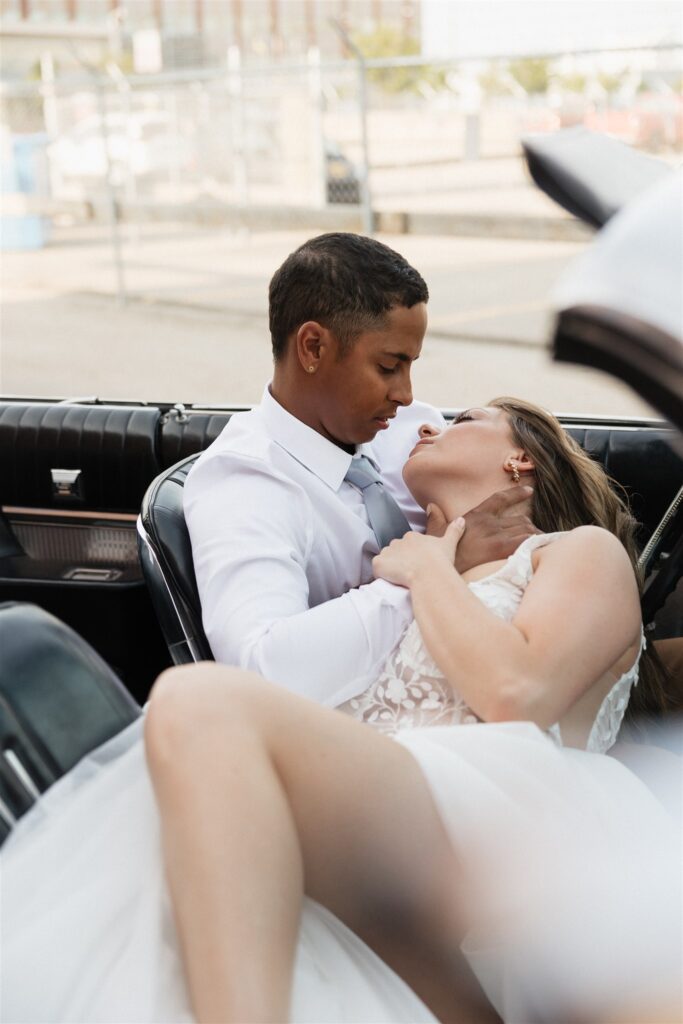 bride and groom posing in an urban setting for their downtown wedding portraits - editorial wedding photos
