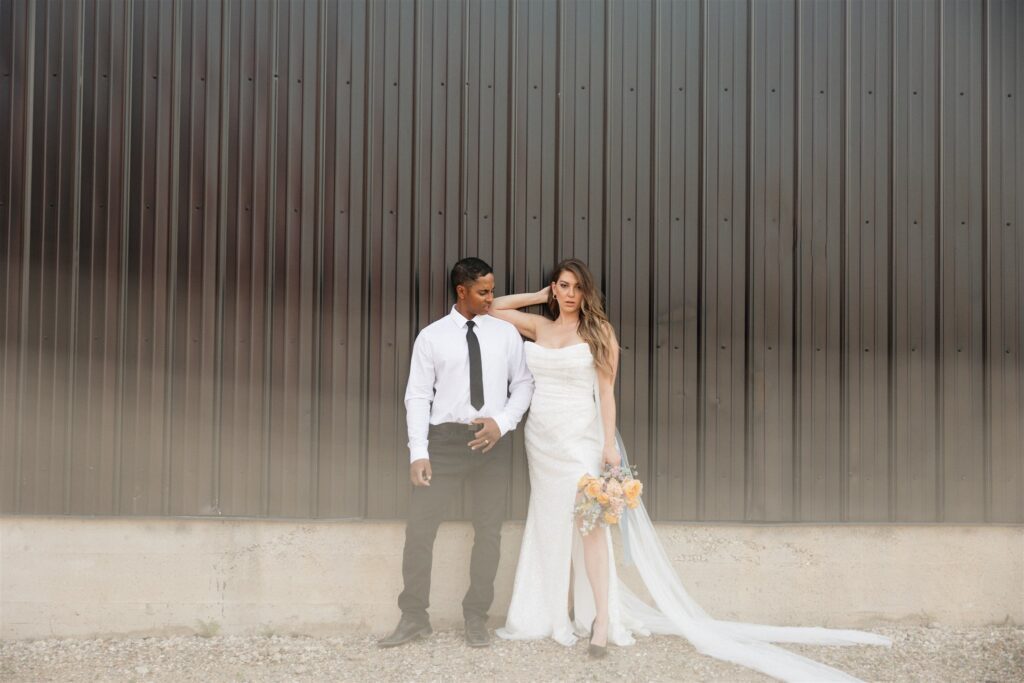 bride and groom posing in an urban setting for their downtown wedding portraits - editorial wedding photos