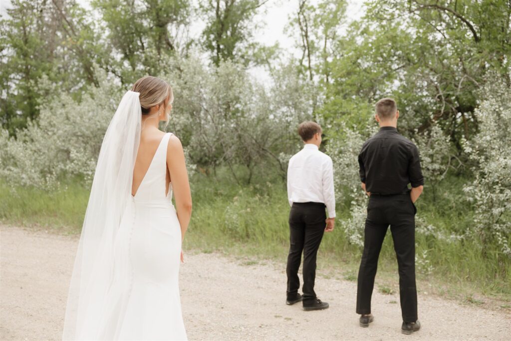 bride doing a first look with her brothers