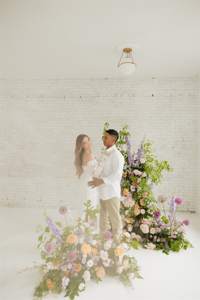 newlyweds posing at a studio in Saskatoon for their wedding portraits | ninth avenue studios