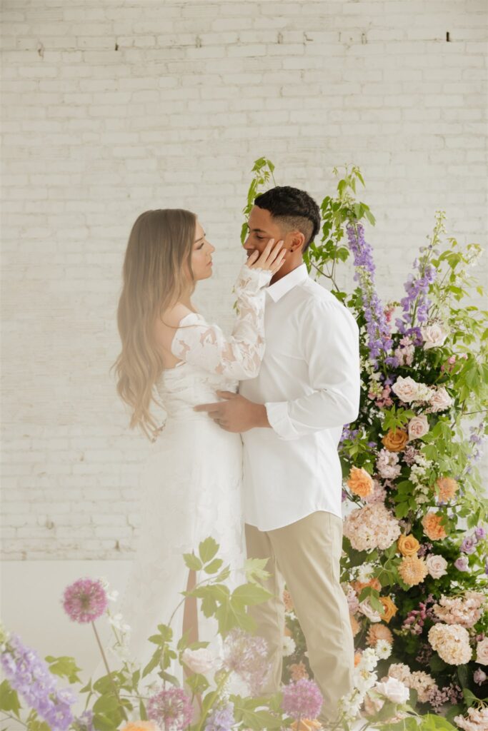 newlyweds posing at a studio in Saskatoon for their wedding portraits | ninth avenue studios