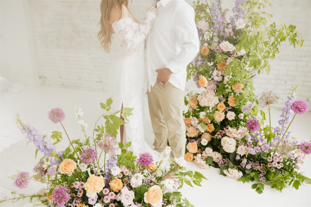 newlyweds posing at a studio in Saskatoon for their wedding portraits | ninth avenue studios