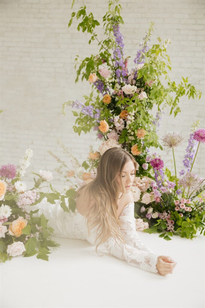 bride posing for her wedding portraits at a studio