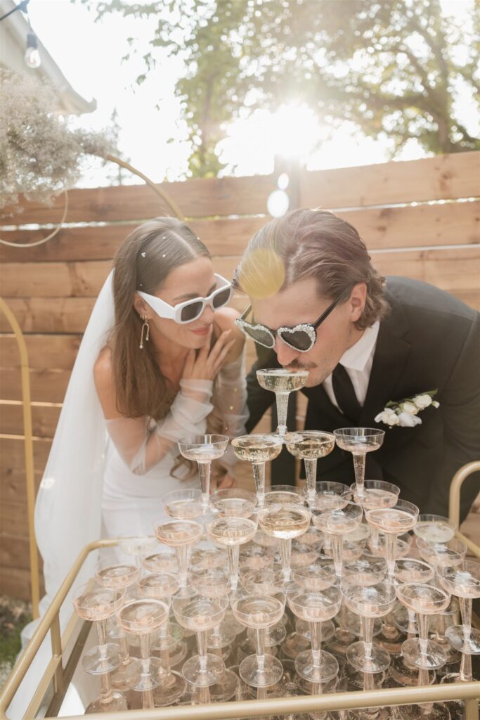 couple doing a champagne fountain after their ceremony.