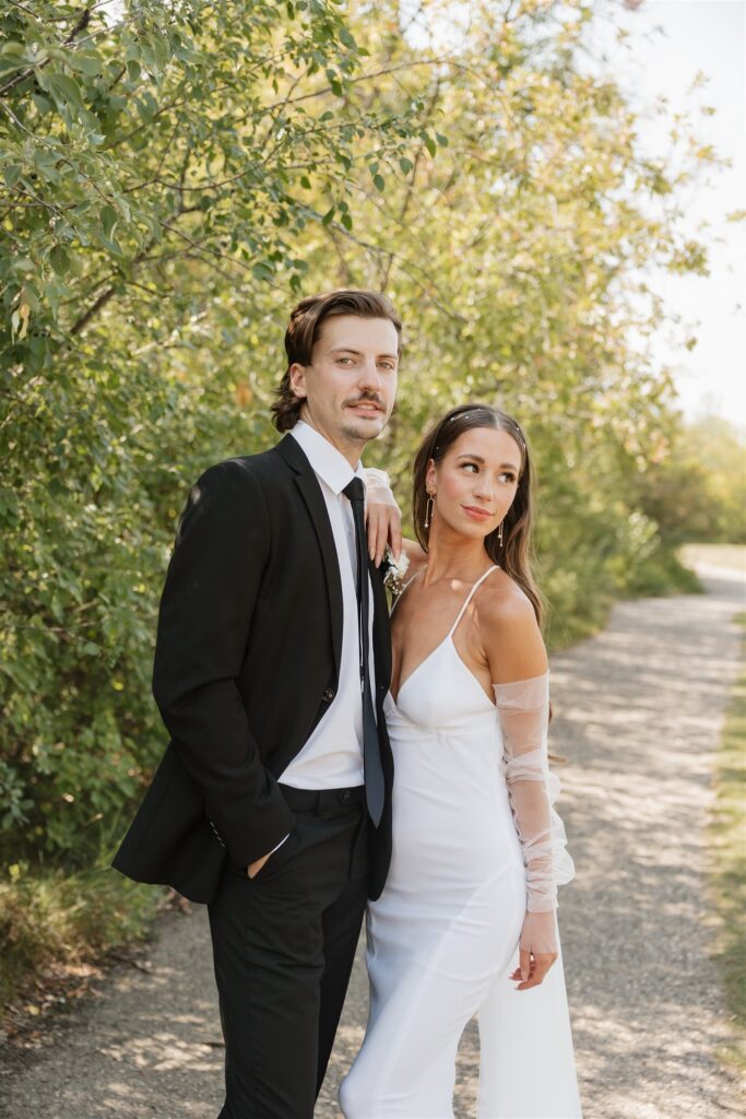 bride and groom posing for their wedding portraits - wedding in moosejaw 