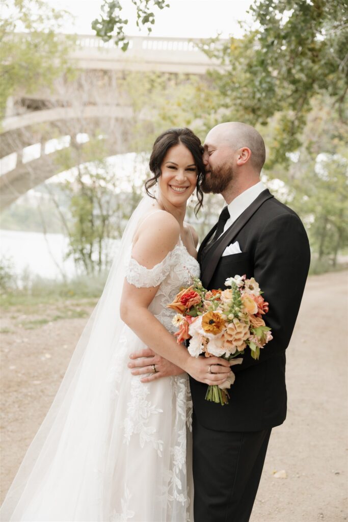 bride and groom posing in saskatoon for their wedding day photos