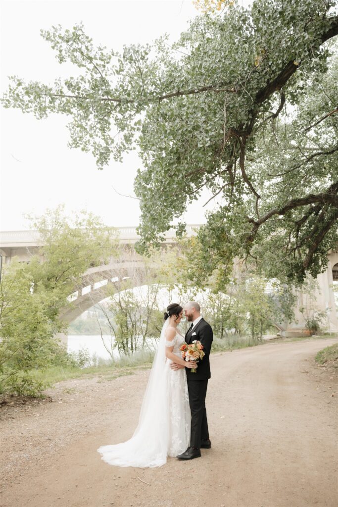 bride and groom posing in saskatoon for their wedding day photos