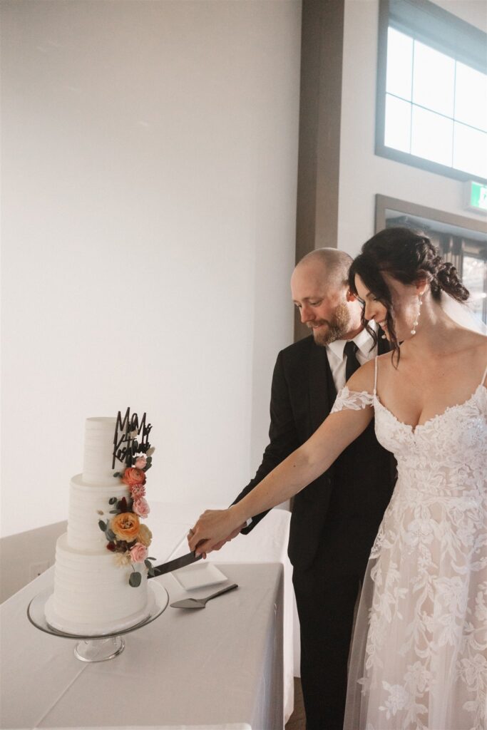 bride and groom cutting cake