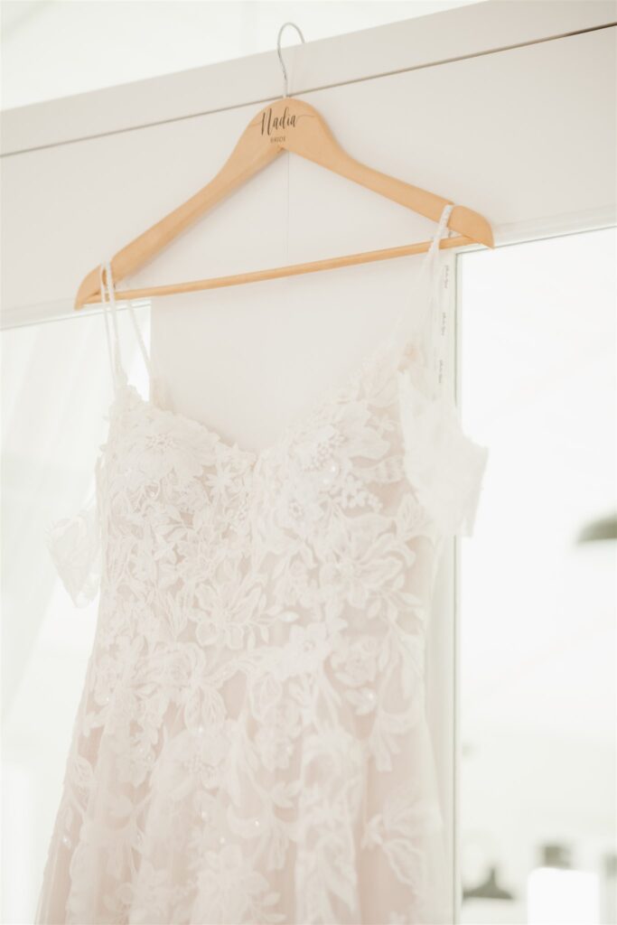 luxurious wedding photography of wedding dress hanging up