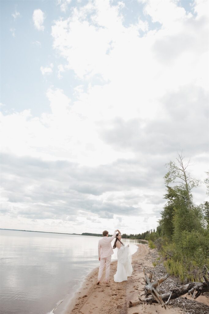 couple posing on a lake for their wedding photos
