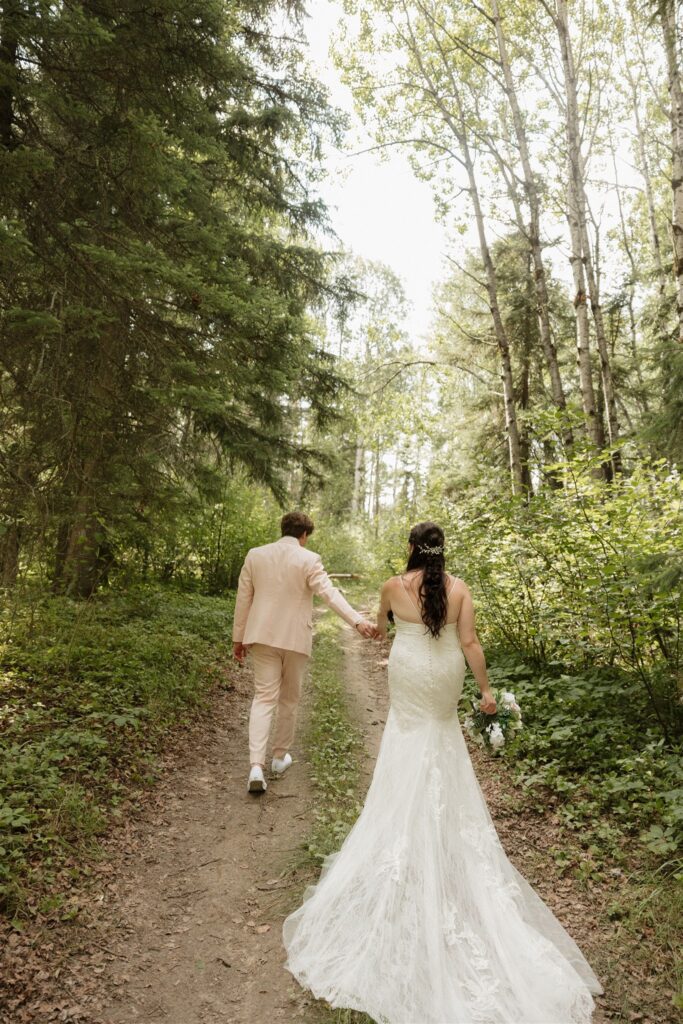 bride and groom posing for their wedding photos in a forest