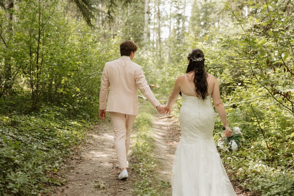 bride and groom posing for their wedding photos in a forest