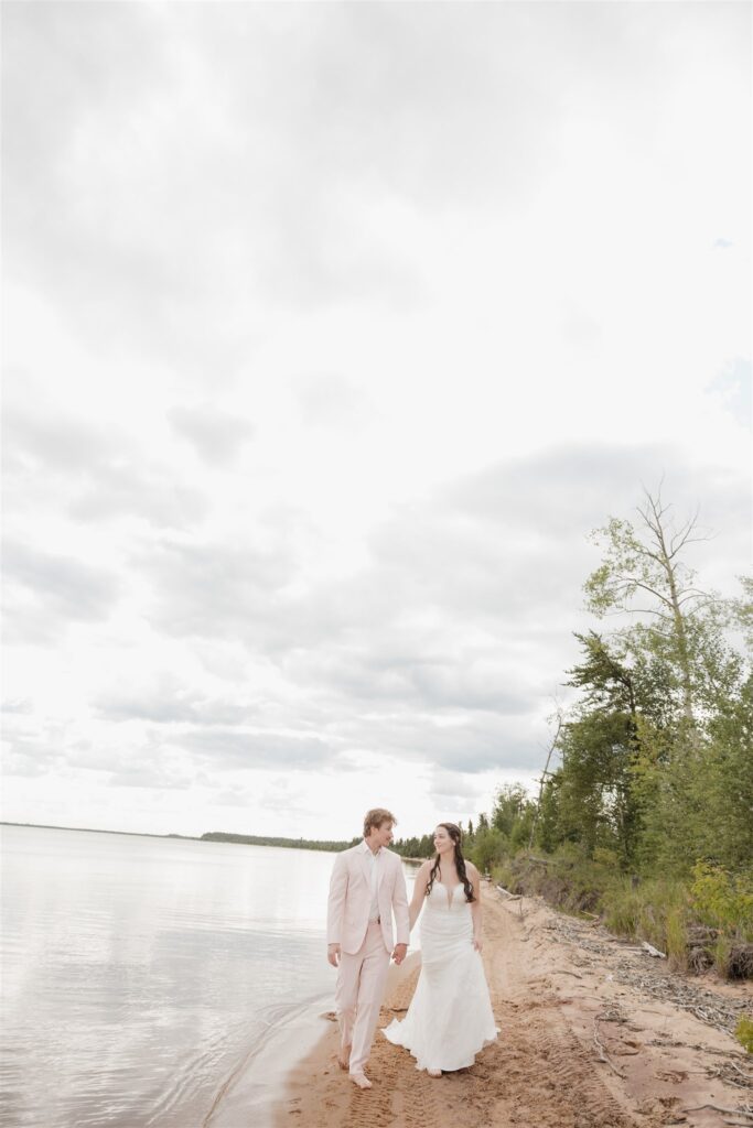 bride and groom posing outdoors for their wedding photos at Lac La Plonge in Saskatchewan outdoor wedding