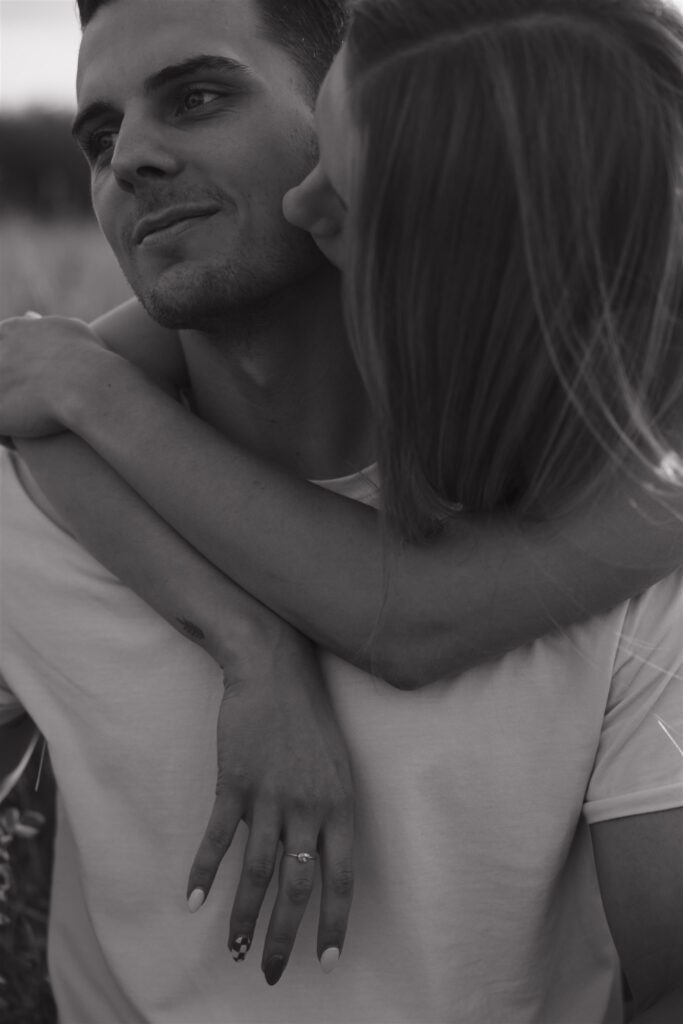 couples posing in a field in canada
